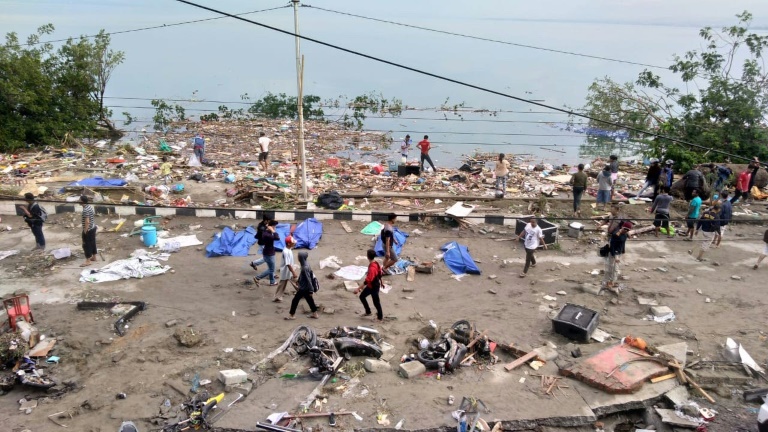 Photographs from Palu -- home to around 350,000 -- showed partially covered bodies on the ground near the shore