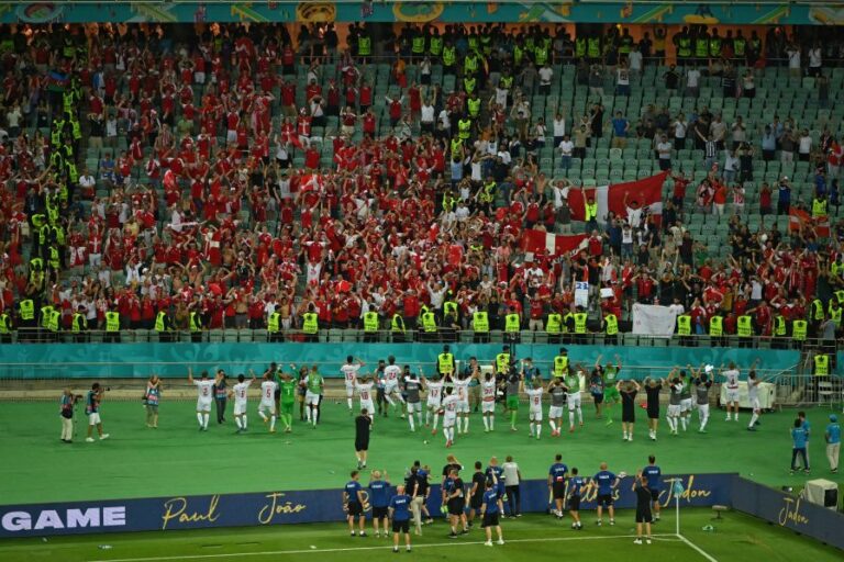 Denmark players celebrate with their fans at the end of the UEFA EURO 2020 quarter-final football match between the Czech Republic and Denmark at the Olympic Stadium in Baku on July 3, 2021. (Photo by DAN MULLAN / POOL / AFP) Denmark continued their remarkable run at Euro 2020 by beating the Czech Republic